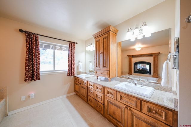 bathroom with vanity, a multi sided fireplace, and tile patterned floors