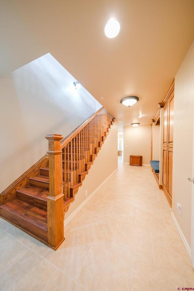 stairway with tile patterned floors