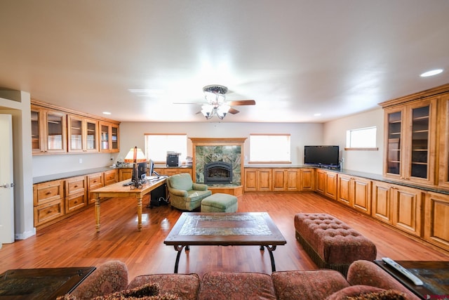 living room with light wood-type flooring and ceiling fan