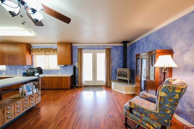 kitchen featuring ornamental molding, a wood stove, dark hardwood / wood-style floors, and ceiling fan