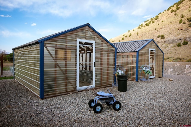 view of outbuilding featuring a mountain view