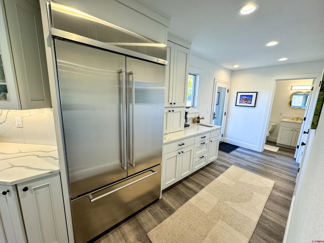 bathroom featuring vanity, toilet, and hardwood / wood-style floors