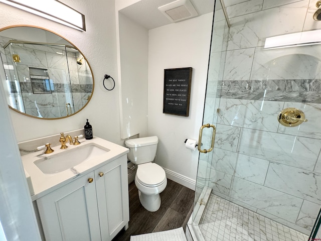 bathroom with a shower with door, vanity, hardwood / wood-style flooring, and toilet