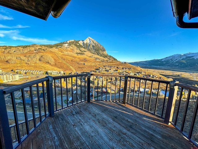 wooden deck with a mountain view