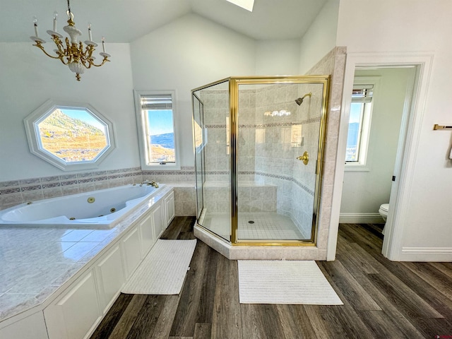 bathroom with toilet, wood-type flooring, separate shower and tub, and vaulted ceiling