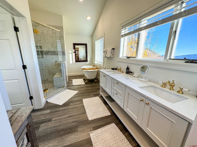 bathroom featuring vanity, lofted ceiling, hardwood / wood-style floors, and plus walk in shower