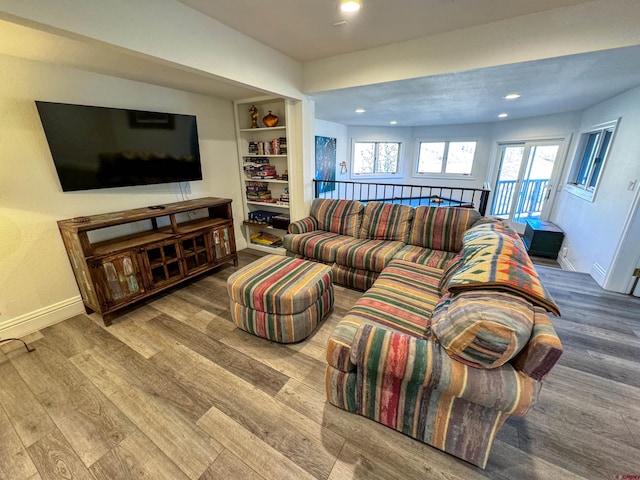 living room featuring light hardwood / wood-style floors and built in features