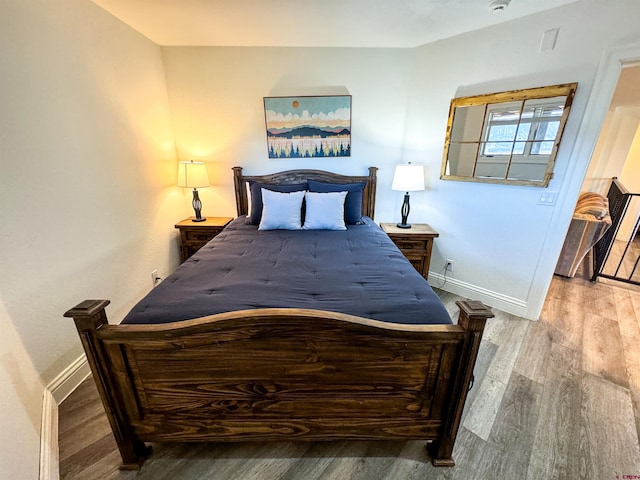 bedroom with hardwood / wood-style floors