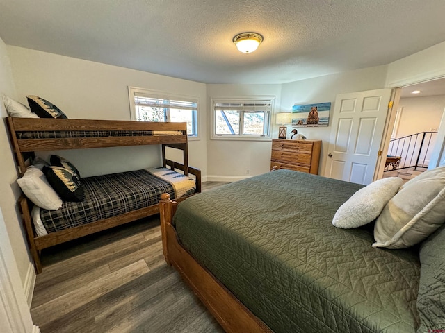 bedroom featuring hardwood / wood-style floors and a textured ceiling