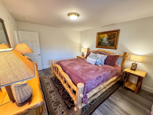 bedroom with dark wood-type flooring