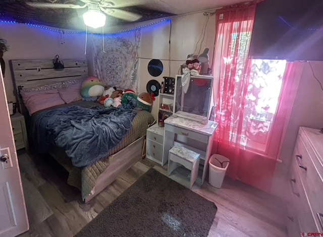 bedroom with light hardwood / wood-style flooring and ceiling fan