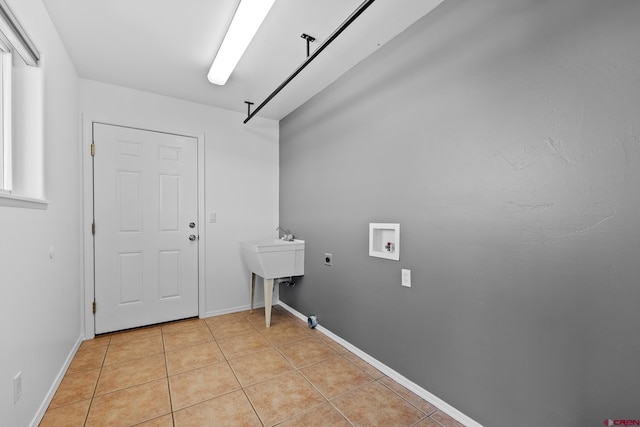 laundry room featuring hookup for a washing machine, electric dryer hookup, and light tile patterned floors