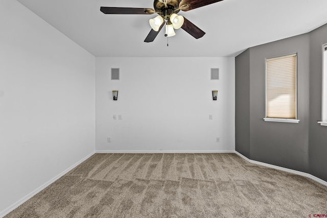 carpeted spare room with ceiling fan