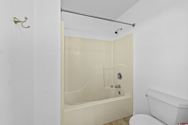 bathroom featuring toilet, shower / bath combination, and tile patterned floors