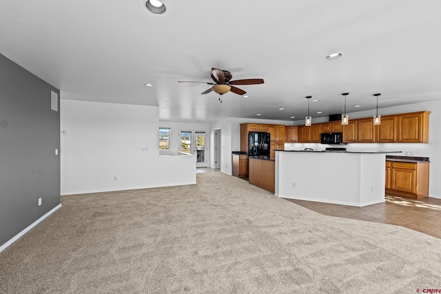 unfurnished living room with light colored carpet and ceiling fan