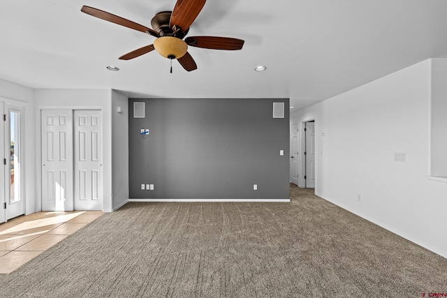 unfurnished living room with light colored carpet and ceiling fan