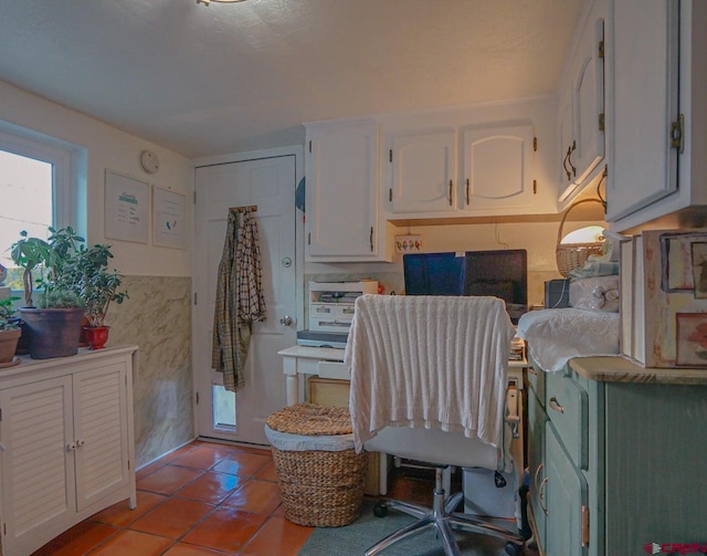 kitchen with white cabinetry and tile patterned flooring