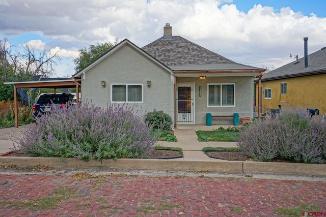 bungalow featuring a carport