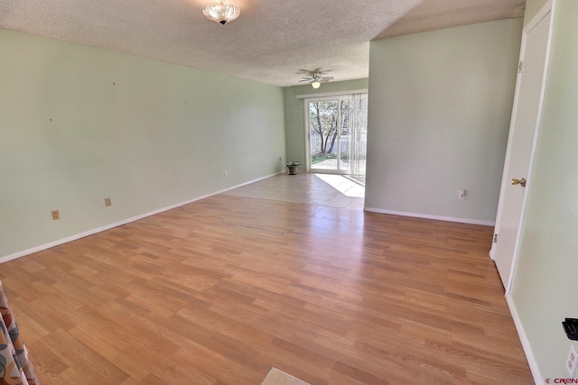 empty room featuring light hardwood / wood-style floors, a textured ceiling, and ceiling fan