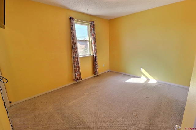 unfurnished room featuring a textured ceiling and carpet floors