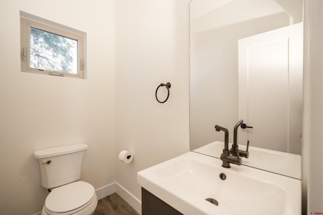 bathroom with vanity, hardwood / wood-style flooring, and toilet