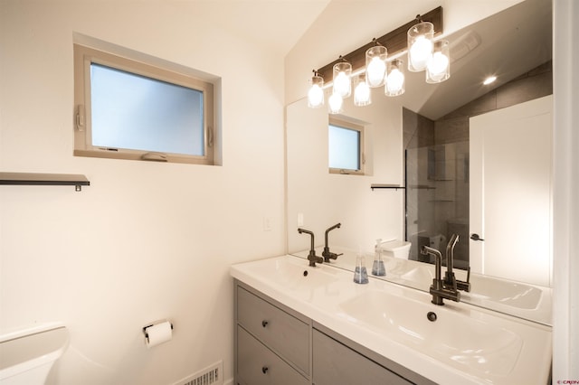 bathroom featuring vanity, lofted ceiling, toilet, and an enclosed shower