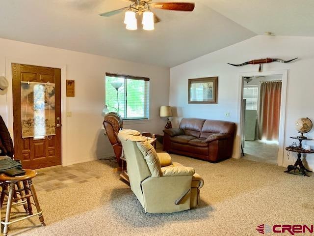 carpeted living room featuring lofted ceiling and ceiling fan