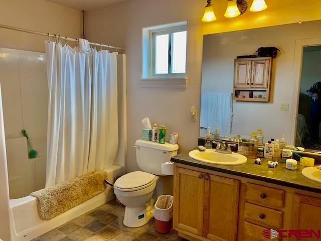 full bathroom with vanity, toilet, and shower / tub combo