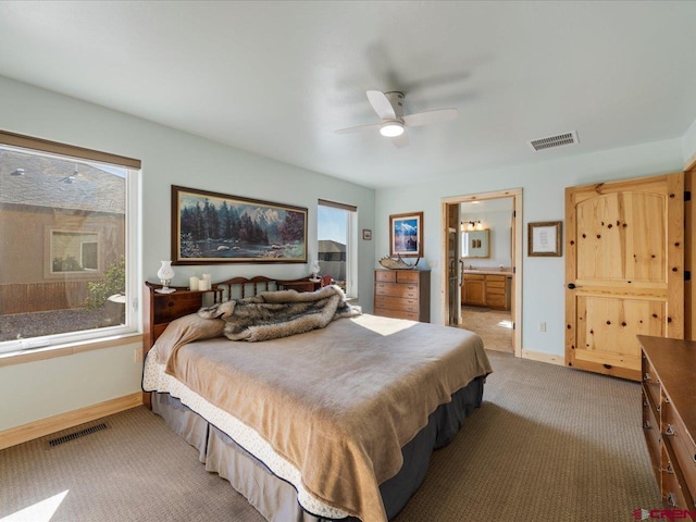 carpeted bedroom featuring connected bathroom and ceiling fan