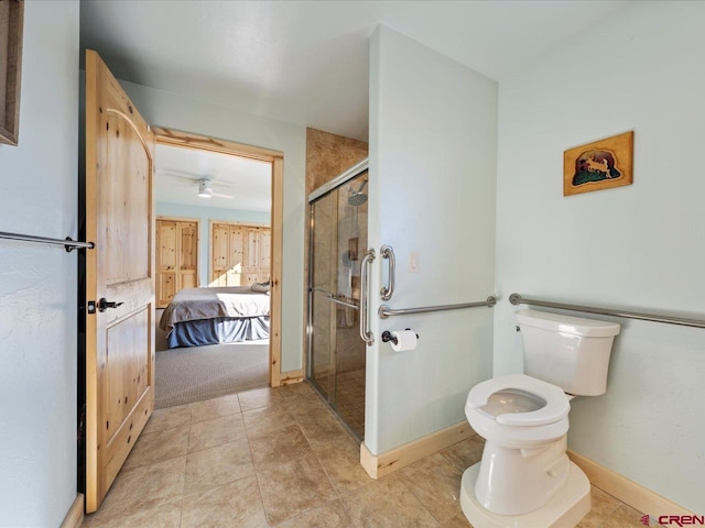 bathroom featuring toilet, ceiling fan, a shower with shower door, and tile patterned flooring