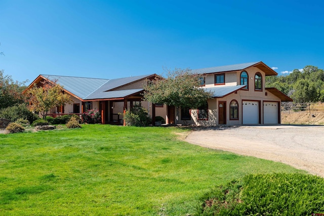 view of front of home with a front yard and a garage