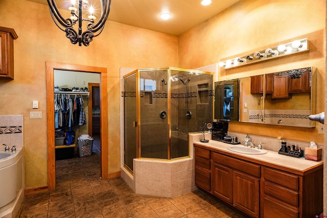 bathroom featuring vanity, an inviting chandelier, and walk in shower