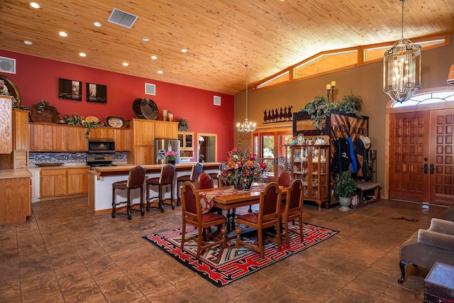 dining space with high vaulted ceiling and wooden ceiling