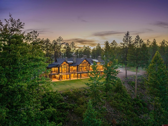 view of back house at dusk