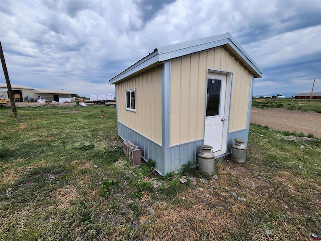 view of outdoor structure featuring a lawn