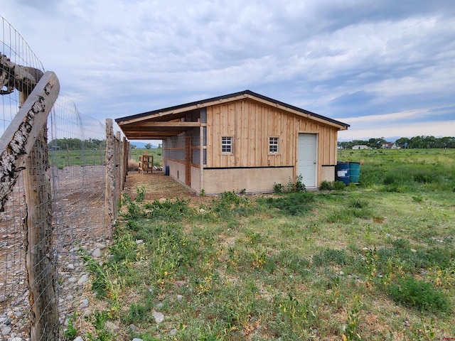 view of outdoor structure with a garage and a rural view