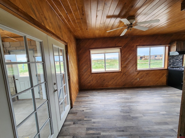 unfurnished sunroom featuring french doors, wood ceiling, and ceiling fan