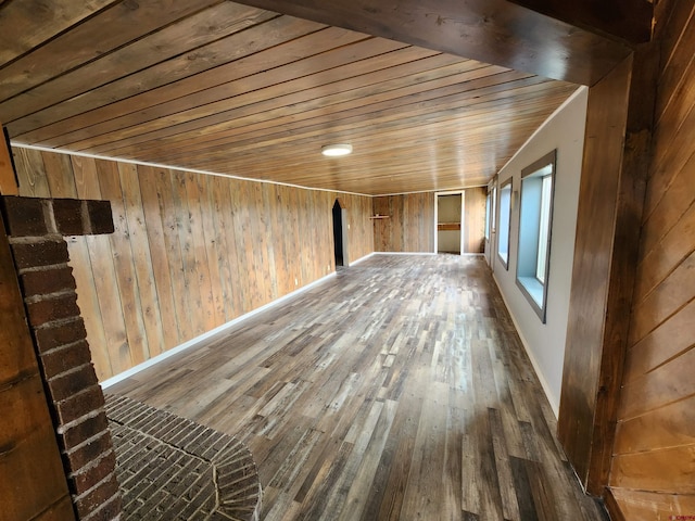 empty room featuring wood ceiling, wooden walls, and dark wood-type flooring