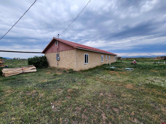 view of home's exterior with a lawn