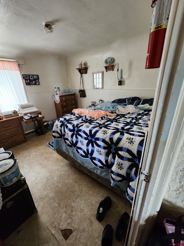 bedroom featuring concrete flooring and a textured ceiling