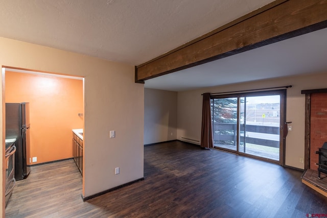 unfurnished living room with dark wood-type flooring, beamed ceiling, a baseboard heating unit, and a wood stove