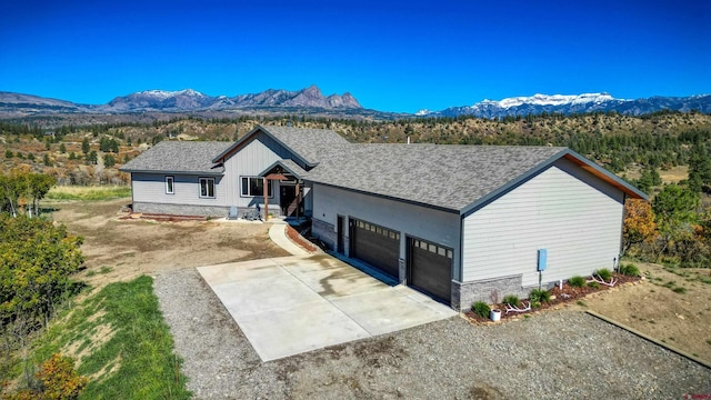 single story home with a garage and a mountain view