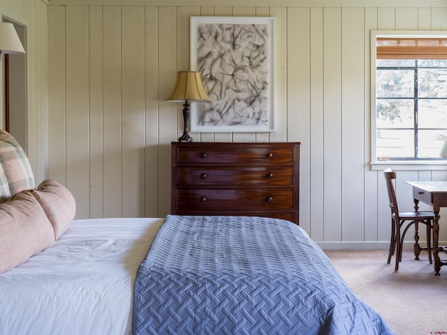 carpeted bedroom with wooden walls