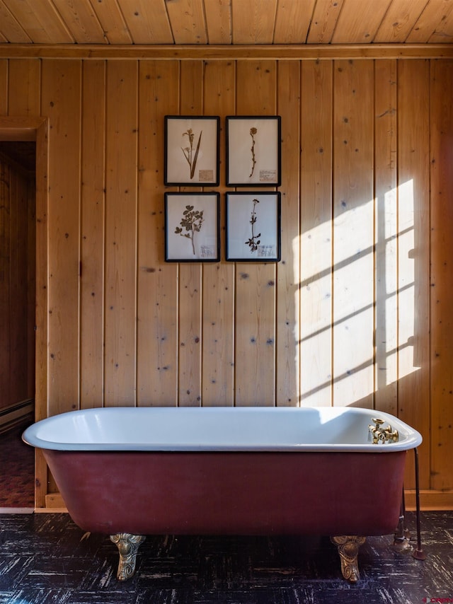 bathroom with wood walls, wooden ceiling, and a bathing tub