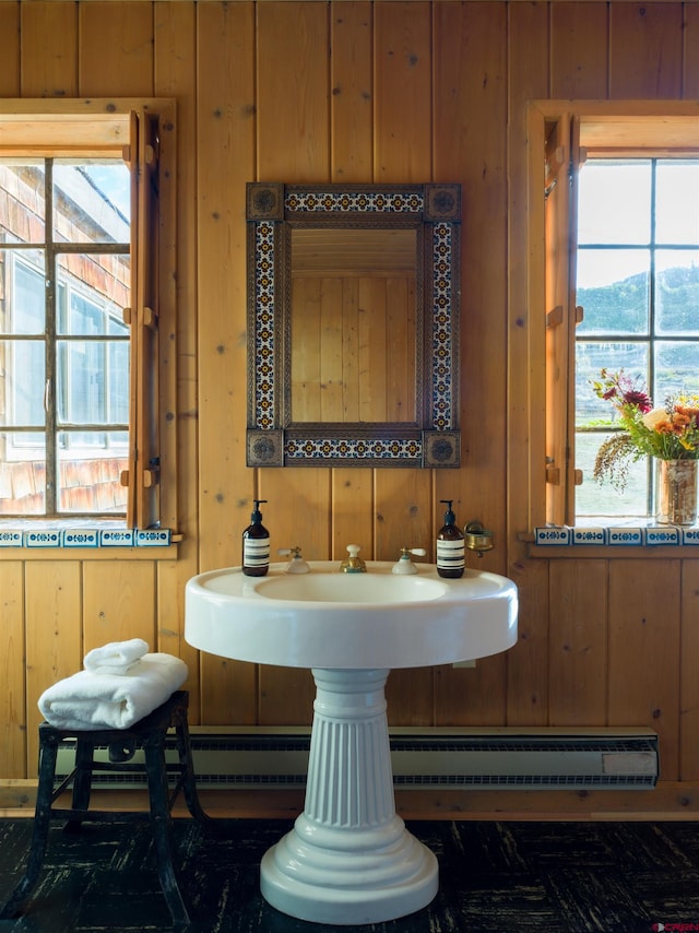 bathroom with wooden walls, a baseboard heating unit, and a mountain view