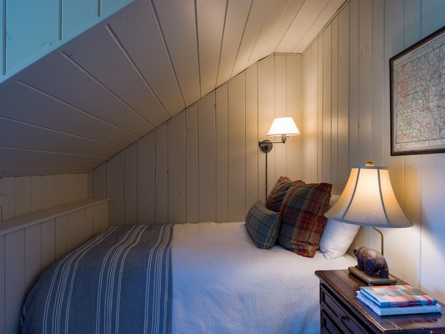 carpeted bedroom featuring wood walls, wooden ceiling, and lofted ceiling