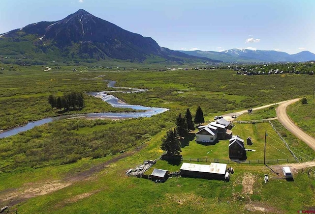 birds eye view of property featuring a mountain view and a rural view