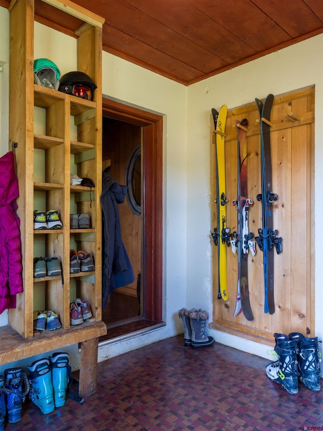 mudroom with dark colored carpet and wood ceiling