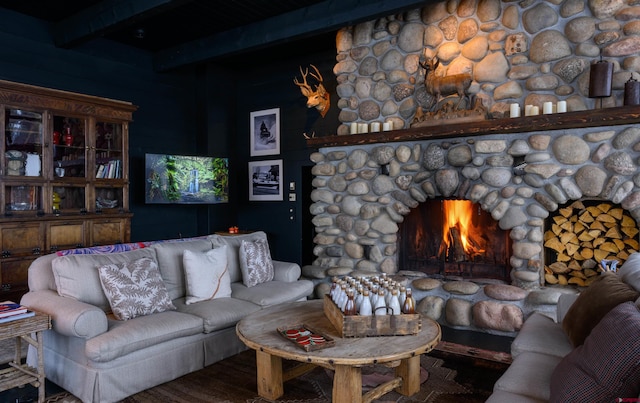 living room featuring beam ceiling, a fireplace, and hardwood / wood-style flooring