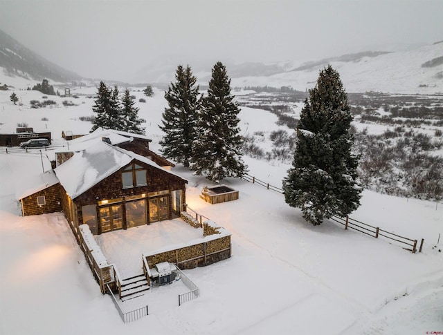 snowy aerial view with a mountain view